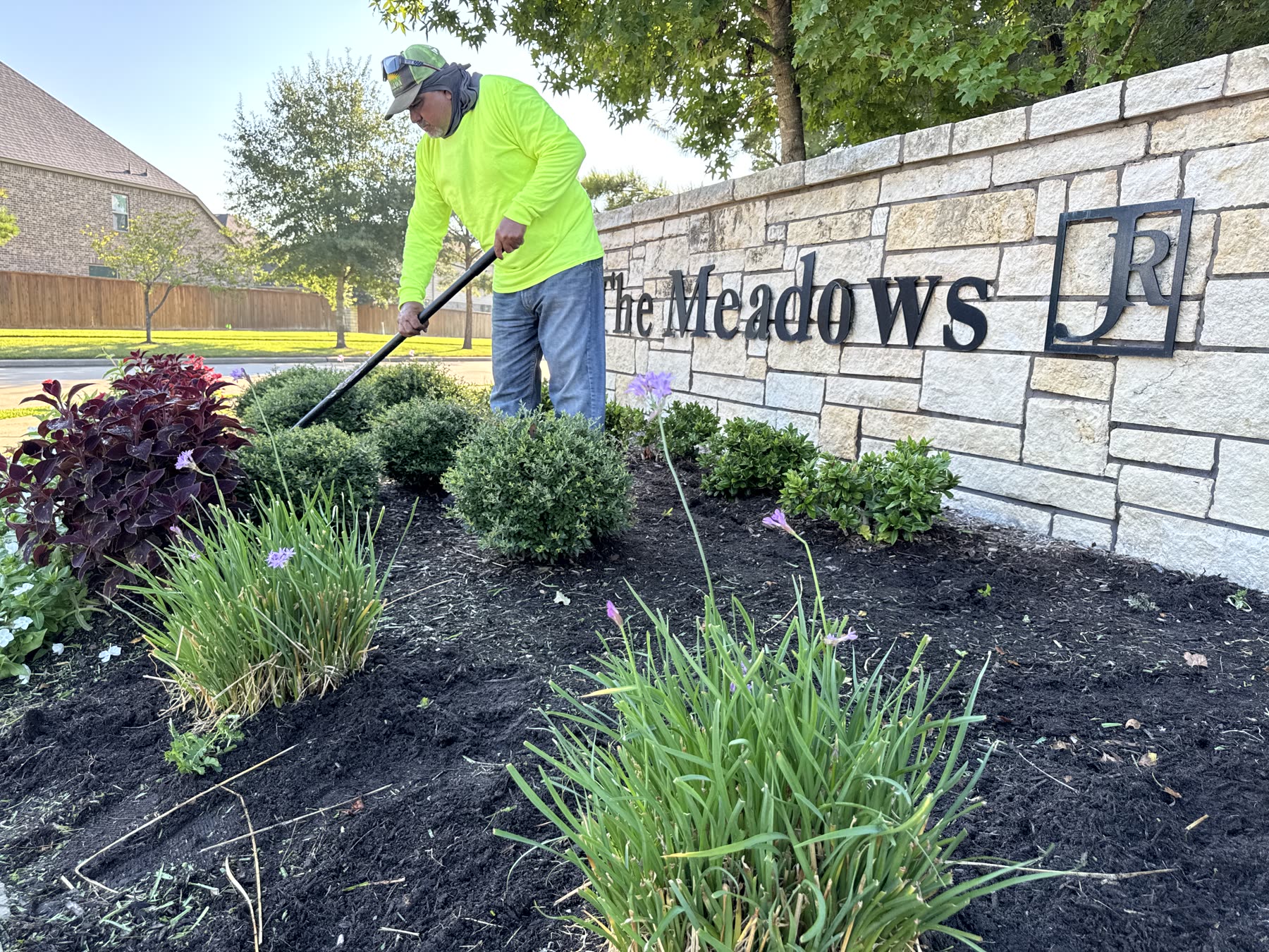 Freshly mulched beds along community wall